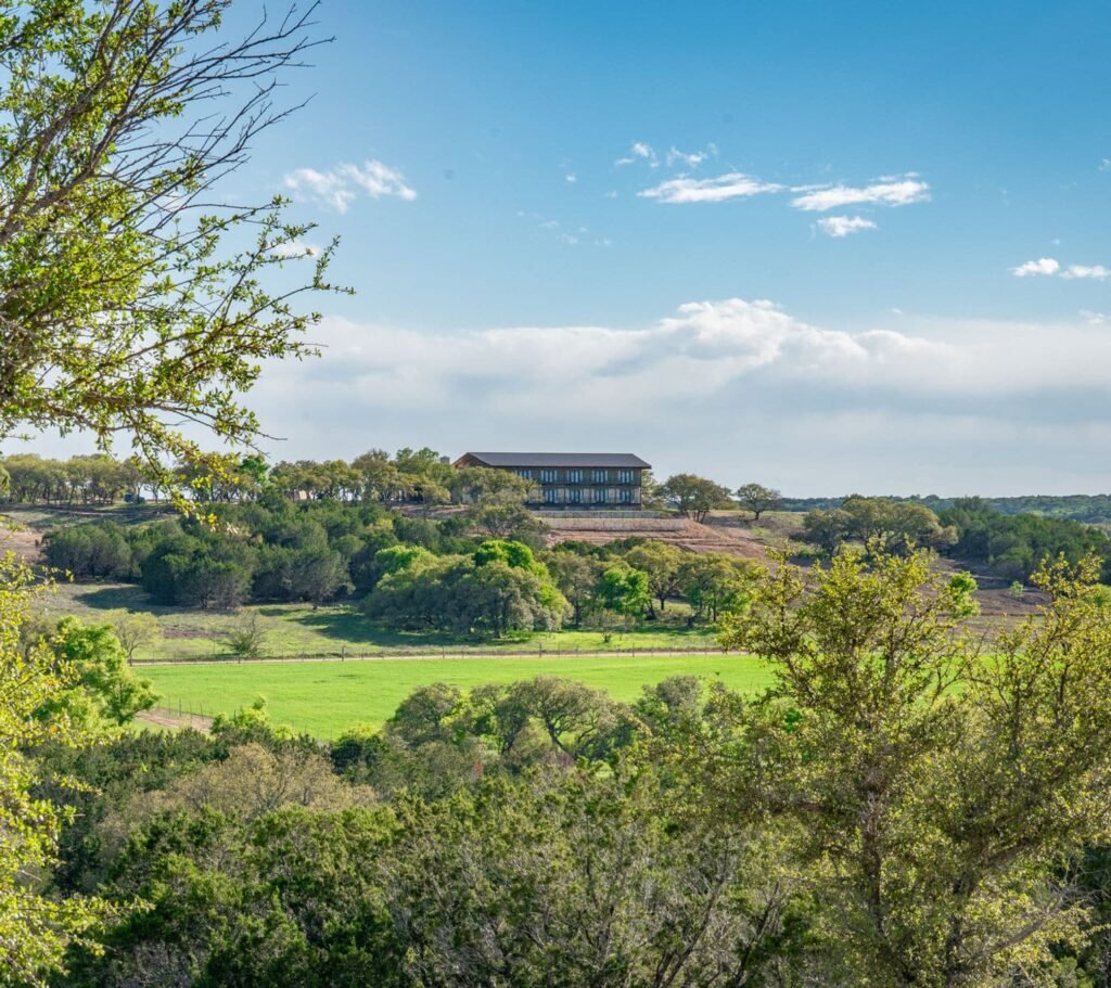 The Lodge at Artemis ranch in the distance with rolling green pastures