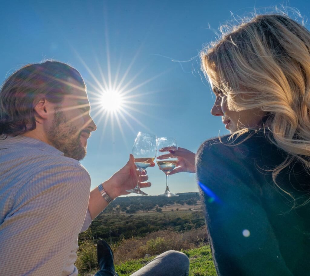 Couple drinking wine on a romantic picnic overlooking Texas ranch view